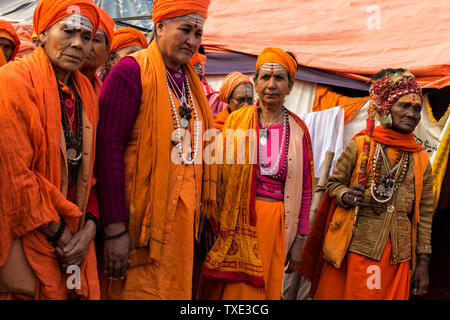 Sadhvi in orange red saree during Allahabad Kumbh Mela, World’s largest religious gathering, Uttar Pradesh, India Stock Photo