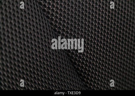 Close-up black car seat trim. Soft rough carbon fabric texture. Stock Photo