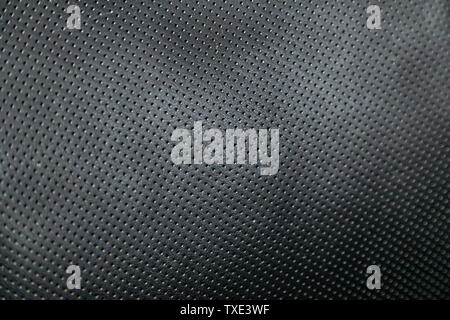 Close-up black car seat trim. Soft rough carbon fabric texture. Stock Photo