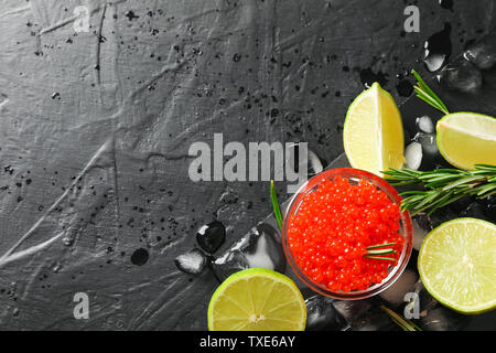 Fresh composition with caviar and citrus on black table, top view Stock Photo