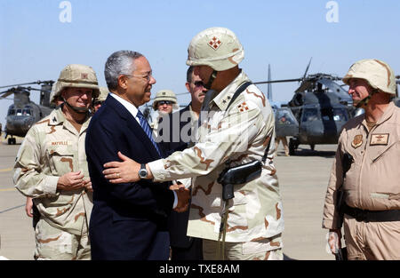 AFIE2003091605 - KIRKUK, IRAQ, SEPT. 15, 2003 (UPI) --  Secretary of State Colin Powell shakes hands with Major General Raymond T. Odierno, Commander US Army 4th Infantry Division, as Colonel William Mayville, Commander 173rd Airborne Brigade, and Colonel James P. Callahan, Commander 506th Air Expeditionary Group, watche on Sept. 15, 2003.  Secretary Powell made a recent stop at Kirkuk AB, Iraq.     RLW/AFIE/Charlein C. Sheets    UPI Stock Photo