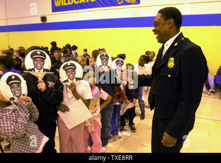 SLP2000012602 - 26 JANUARY 2000 - ST. LOUIS, MISSOURI, USA: St. Louis Fire Chief Sherman George gets a chuckle as first grade students at Woodward Elementary School in south St. Louis sport faces of the newly appointed fire chief, January 26. The students were celebrating Sherman George Day at the school.   rg/bg/Bill Greenblatt    UPI Stock Photo