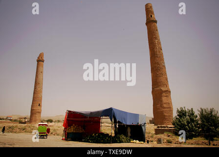 An Afghan melon seller shop stands on the side of the road next to the ruins of the 15th century Musalla complex's minarets in Herat, Afghanistan on August 12, 2009. Afghanistan's presidential election will be held on August 20.   UPI/Mohammad Kheirkhah Stock Photo