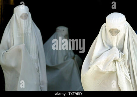 White Burqa-clad women leave the Blue Mosque after their prayers in Mazar-e-Sharif (Tomb of the Exalted), Afghanistan on August 24, 2009. During the month of Ramadan, the ninth month of the Islamic calendar, Muslims abstain from eating, drinking and smoking from sunrise to sunset. Mazar-e-Sharif is the fourth largest city of Afghanistan and is located on north.  UPI/Mohammad Kheirkhah Stock Photo