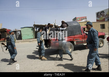 Afghan police patrol the streets during riots in Kabul on September 15, 2010. Hundreds of Afghans poured onto the streets of Kabul to protest against plans, canceled days ago, by a US pastor to burn copies of the Koran, officials and witnesses said. The demonstrators threw rocks at anti-riot police after the officers prevented them from marching towards the city center, an interior ministry spokesman said.   UPI Stock Photo