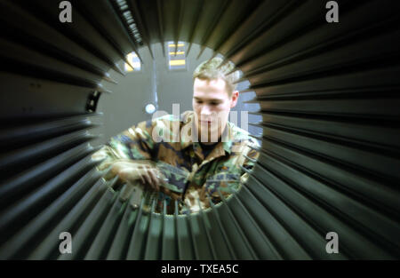 Senior Amn. Nathan Sundberg checks the spacing of the UALS (Universal Ammunition Loading System) of an F-16C.  SrA Sundberg is a member of the 114th Fighter Wing, South Dakota Air National Guard which was being evaluated by the ACC/IG team during their Unit Compliance Inspection held on Oct. 2-7, 2003.   (UPI/Mike Chambers/USAF) Stock Photo