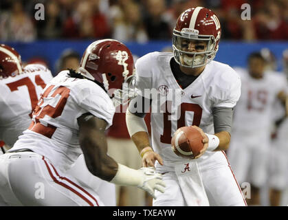 Alabama quarterback AJ McCarron (10) hands off to running back Eddie Lacy in the first half of their SEC Championship college football game against Georgia at the Georgia Dome in Atlanta on December 1, 2012.      UPI/David Tulis Stock Photo