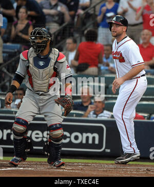 Cleveland Indians catcher Carlos Santana (L) waits on the throw as Atlanta Braves' Brian McCann (R) scores on the RBI single in the second inning at Turner Field in Atlanta, August 28, 2013. Braves' Jordan Schafer hit an RBI single for the score. UPI/David Tulis Stock Photo