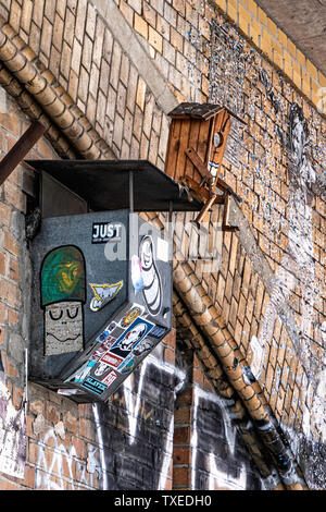 Street art and unusual bird nesting box on brick railway viaduct in Mitte-Berlin Stock Photo