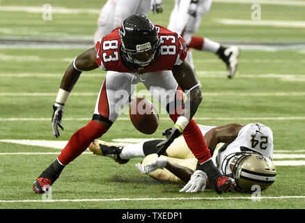 Atlanta Falcons wide receiver Harry Douglas (83) can't hold onto the football under pressure by New Orleans Saints cornerback Corey White (24) during the first half of their football game at the Georgia Dome in Atlanta on September 7, 2014. UPI/David Tulis Stock Photo