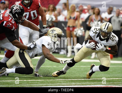 New Orleans Saints cornerback Corey White (24) recovers the fumble in front of Atlanta Falcons guard Jon Asamoah (75) and offensive tackle Jake Matthews (70) during the first half of their football game at the Georgia Dome in Atlanta on September 7, 2014. UPI/David Tulis Stock Photo