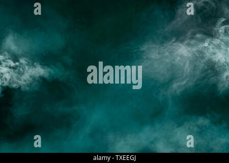 white smoke isolated in color green background Stock Photo