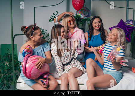 Beautiful young girls laughing at a party. Homemade bachelorette party Stock Photo