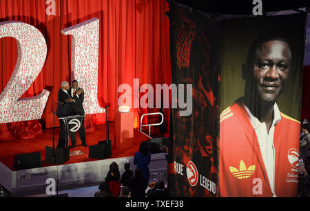 Basketball great Julius Erving (L) hugs Dominique Wilkins during a statue unveiling for Wilkins, the longtime Atlanta Hawks and All-Star NBA player, at Philips Arena in Atlanta, March 5, 2015. The 13.5-foot-tall, 18,500-lb. structure created by Brian Hanlon features Wilkins, known to basketball players and fans as 'the human highlight film,' in a signature pose and will be moved outside the basketball arena for permanent display. Photo by David Tulis/UPI Stock Photo