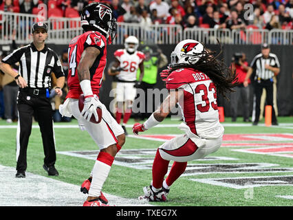 Atlanta Falcons wide receiver Justin Hardy (14) catches a 5-yard touchdown pass in front of Arizona Cardinals defensive back Tre Boston (33) during the second half of an NFL game at Mercedes-Benz Stadium in Atlanta, December 16, 2018. Atlanta won 40-14.  Photo by David Tulis/UPI Stock Photo