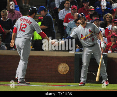 St. Louis Cardinals Lance Berkman embraces Albert Pujols after the  Cardinals won the 2011 World Series in St. Louis on October 28, 2011. The  Cardinals defeated the Texas Rangers 6-2 winning game