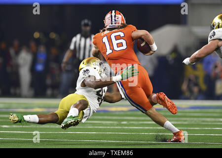 Notre Dame Fighting Irish defensive lineman Julian Okwara (42) tries to tackle Clemson Tigers quarterback Trevor Lawrence (16) during the first half of the College Football Playoff Semifinal at the Goodyear Cotton Bowl Classic at AT&T Stadium in Arlington, Texas on December 29, 2018. Photo by Shane Roper/UPI Stock Photo