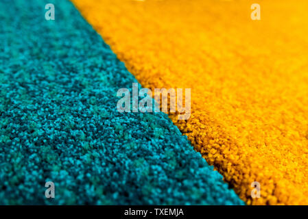 Turquoise and orange floor carpet. Perspective view with selected focus. Stock Photo