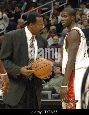 Atlanta Hawks coach Mike Woodson holds the game ball while he offers words of advice to Marvin Williams (24) in the first half in Atlanta's Philips Arena December 27, 2005. The Bobcats defeated the Hawks 93-90. (UPI Photo/John Dickerson) Stock Photo