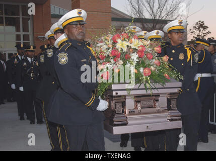 Members of the City of Atlanta Police Department Honor Guard carry the casket containing the body of Coretta Scott King after her funeral service at the New Birth Missionary Baptist Church in Lithonia, Ga.,  February 7, 2006. Coretta Scott King was the wife of Dr. Martin Luther King Jr.  (UPI Photo/John Dickerson) Stock Photo