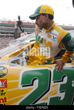 Bill Lester, the first black driver to start a NASCAR Cup race in 20 years, makes a pit stop in ...