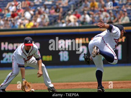 Atlanta Braves first baseman Adam LaRoche (L) fields a ball in play as pitcher Jason Shiell attempts to catch the ball in the second inning against the visiting Florida Marlins July 27, 2006, in Atlanta's Turner Field. The Marlins defeated the Braves 6-1. (UPI Photo/John Dickerson) Stock Photo