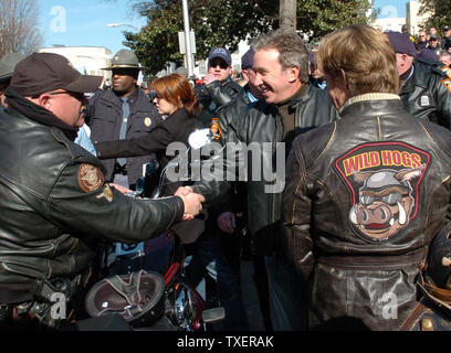 'Wild Hogs' star Tim Allen shakes hands with a motorcycle policeman as fellow star William H. Macy (R) looks on at the Georgia State Capitol on February 6, 2007. The actors promoted a motorcycle safety program and their upcoming comedy film. (UPI Photo/John Dickerson) Stock Photo