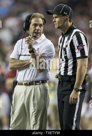 Alabama coach Nick Saban talks with players before the team's spring ...