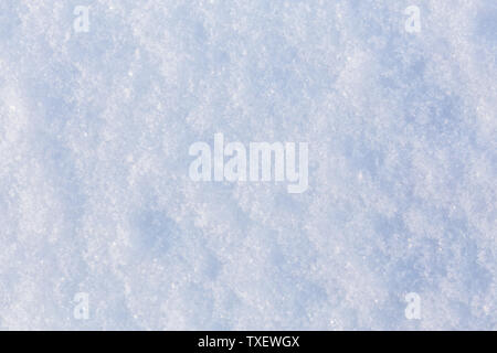 flat closeup texture of snow surface at daylight withs selective focus. Stock Photo