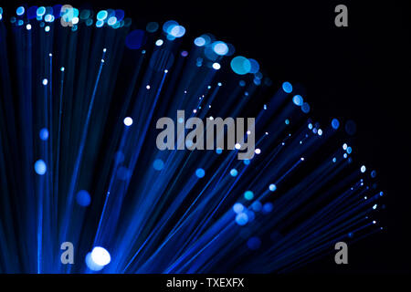 Blue luminous abstract background, digital fiber optic connection concept. Glowing dots and lines on a black background. Stock Photo