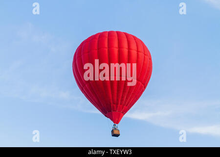 red air balloon flies across the blue sky Stock Photo