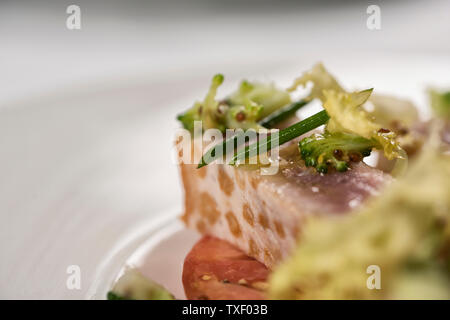 Tuna salad with asparagus, lettuce, carrots and radish, sprinkled with chives. Healthy green salad. Stock Photo