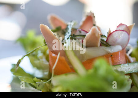 Tuna salad with asparagus, lettuce, carrots and radish, sprinkled with chives Stock Photo