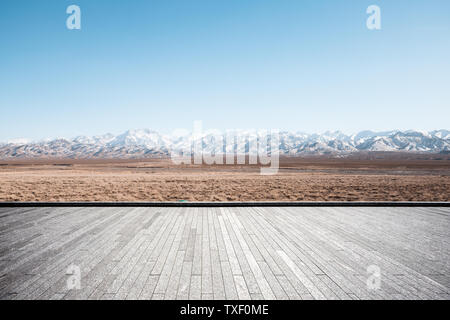 Empty brick floor with snow mountains Stock Photo