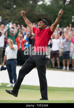 Tiger Woods Celebrates Winning The Masters On The 18th Green With His 