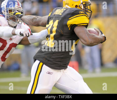 New York Giants Michael Johnson (20) holds up Washington Redskins Clinton  Portis (26) in the first quarter at Giants Stadium in East Rutherford, New  Jersey on September 4, 2008. The Giants defeated