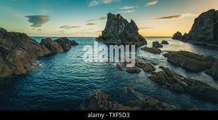 Sunrise light and colours by the shores of Portknockie town near Bow Fiddle Rock formation. Scottish Highlands, United Kingdom, Europe. Stock Photo