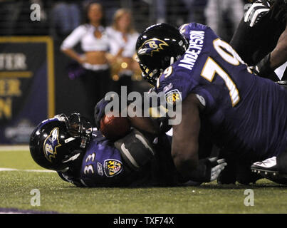 Baltimore Ravens running back Le'Ron McClain tries to escape a tackle from  Tennessee Titans Stephen Tulloch during the first half. The Titans defeated  the Ravens 13-10, at M&T Bank Stadium in Baltimore