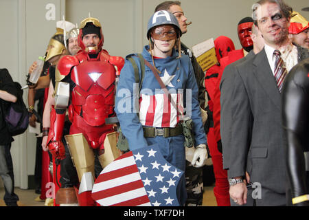 David Santiago (L) as Ares, God of War, and Garrett Gird, as Thor, wait  with others to be judged for the costume contest at the 11th annual Comic  Con in Baltimore on