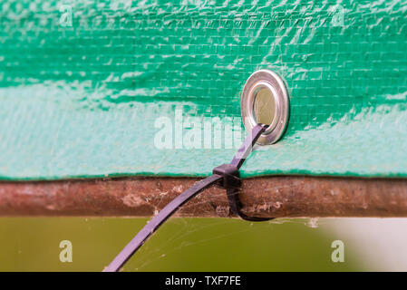 Plastic stripe pies for banner fixing as canopy Stock Photo