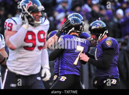 Baltimore Ravens kicker Billy Cundiff (7) is congratulated by teammates after kicking a 44-yard field goal as Houston Texans J.J. Watt leaves the field during the fourth quarter at M&T Bank Stadium in Baltimore, Maryland on January 15, 2012.  UPI/Kevin Dietsch Stock Photo