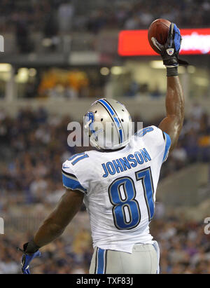 Detroit Lions wide receiver Calvin Johnson (81) runs triumphantly for an  87-yard touchdown after escaping two defenders during second half NFL  action between the New York Giants and Detroit Lions at the