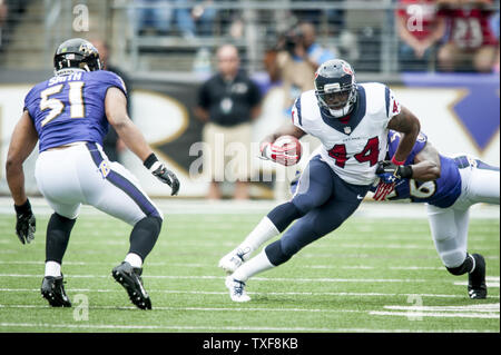 Houston Texans' running back Ben Tate breaks through the Baltimore Ravens' defense during first quarter action at M&T Bank Stadium on September 22, 2013. UPI/Pete Marovich Stock Photo