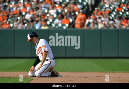 Baltimore Orioles third baseman Manny Machado (13) makes a diving stop on a  ground ball against the Boston Red Sox in the first inning at Orioles Park  at Camden Yards in Baltimore