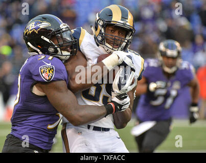 Philadelphia Eagles tight end Zach Ertz (86) is stopped on a short gain by  Baltimore Ravens defenders Tavon Young (L) and C.J. Mosley (R) during the  second half of an NFL game