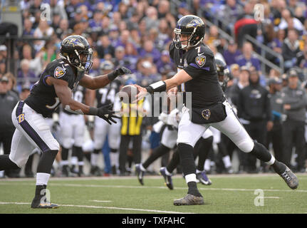 Baltimore Ravens quarterback Ryan Mallett hands off to Baltimore Ravens wide receiver Chris Givens against the Pittsburgh Steelers in Baltimore, Maryland on December 27, 2015. The Ravens defeated the Steelers 20-17. Photo by Kevin Dietsch/UPI Stock Photo