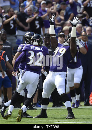 Baltimore Ravens defensive end Timmy Jernigan (97) celebrates sacking San  Diego Chargers quarterback Philip Rivers for a 5-yard loss during the first  half of their football game at M&T Bank Stadium in