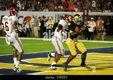 Notre Dame Wide Receiver, Theo Riddick, scores the final touchdown of the game on a six yard touchdown pass during the fourth quarter against Alabama at the BCS National Championship at the Sun Life Stadium in Miami, Florida on January 7, 2013. Alabama won the Championship game 42-14. Stock Photo