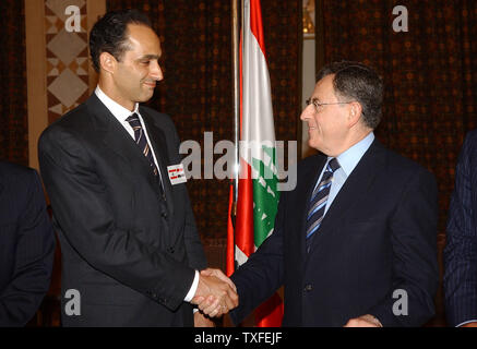 Gamal Mubarak (left), the son of Egyptian President Hosni Mubarak and his possible successor, meets with Lebanese Prime Minister Fouad Saniora in Beirut on August 8, 2006. Mubarak is wearing both the Lebanese and Egyptian flags on his lapel and is visiting Lebanon to show Egyptian solidarity with the Lebanese people. (UPI Photo) Stock Photo
