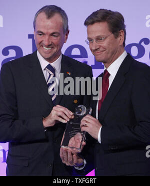 U.S. Ambassador to Germany Philip D. Murphy (L) and German Foreign Minister Dr. Guido Westerwelle display the Freedom Challenge Award after it was awarded to Westerwelle in Berlin on November 8, 2009.  The event recognizes individuals who have fought for democracy and liberty.  The event was held in conjunction with the 20th anniversary of the fall of the Berlin Wall which will be celebrated on November 9 in the German capital.   UPI/David Silpa Stock Photo